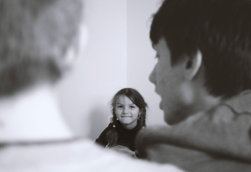 man and woman smiling in grayscale photography