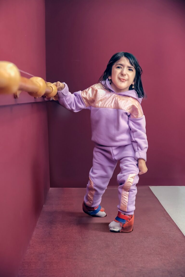 a little girl that is holding a stuffed animal