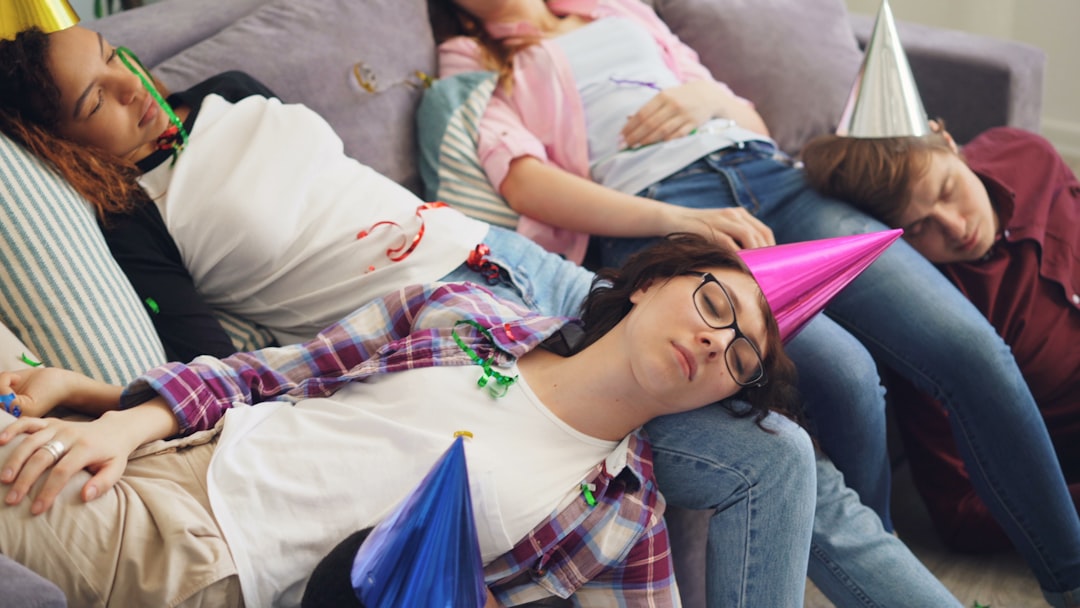 a group of people laying on top of a couch