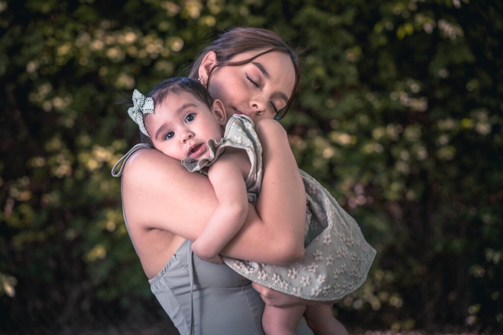 a woman holding a baby in her arms