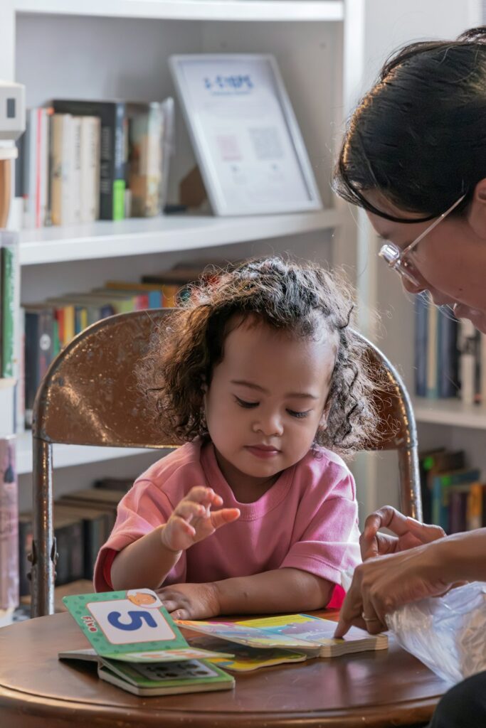 Adult reading a book with a young child.
